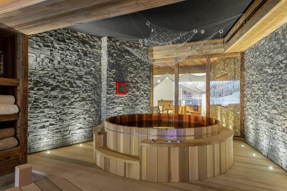 Courchevel 10 hot tub wellness room with cedar tub and stone walls, Courchevel 1850, France