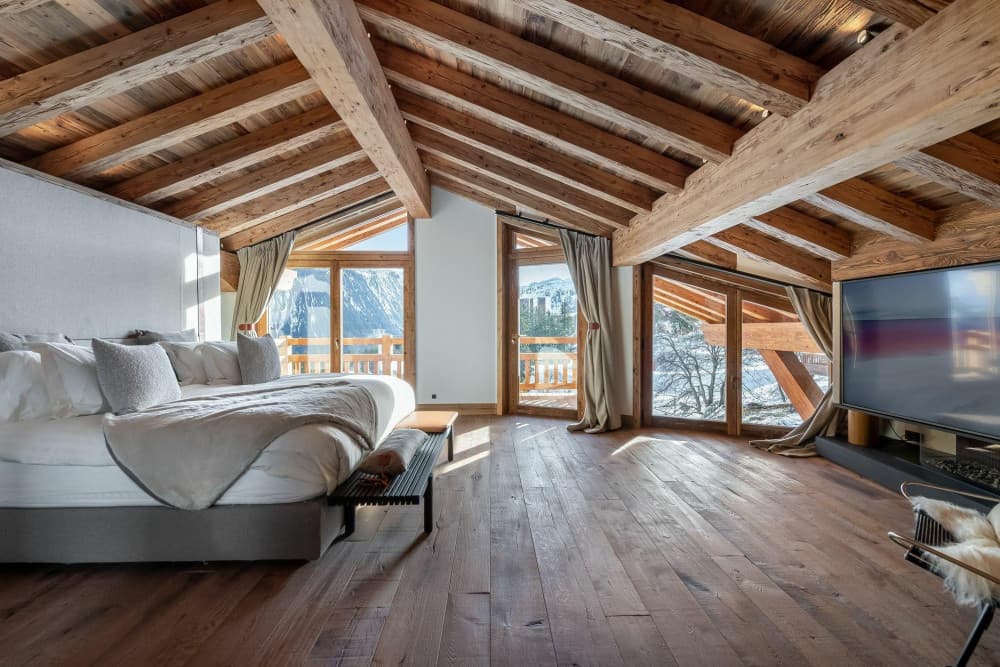 Courchevel 10 master bedroom with vaulted timber ceiling and mountain views, Courchevel 1850, France