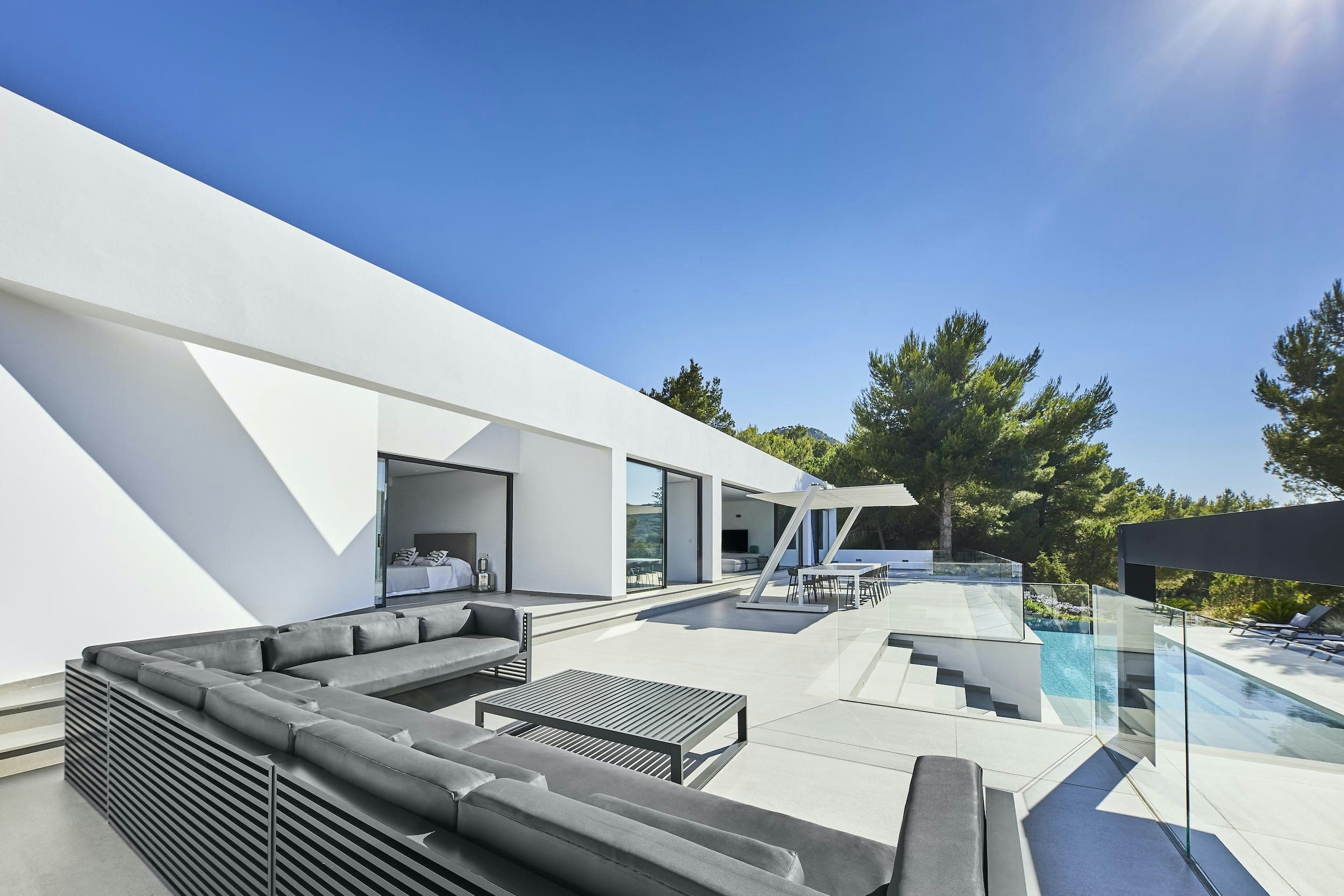 Dancing Shadows outdoor terrace with grey seating and canopy, Sant Josep de sa Talaia, Spain