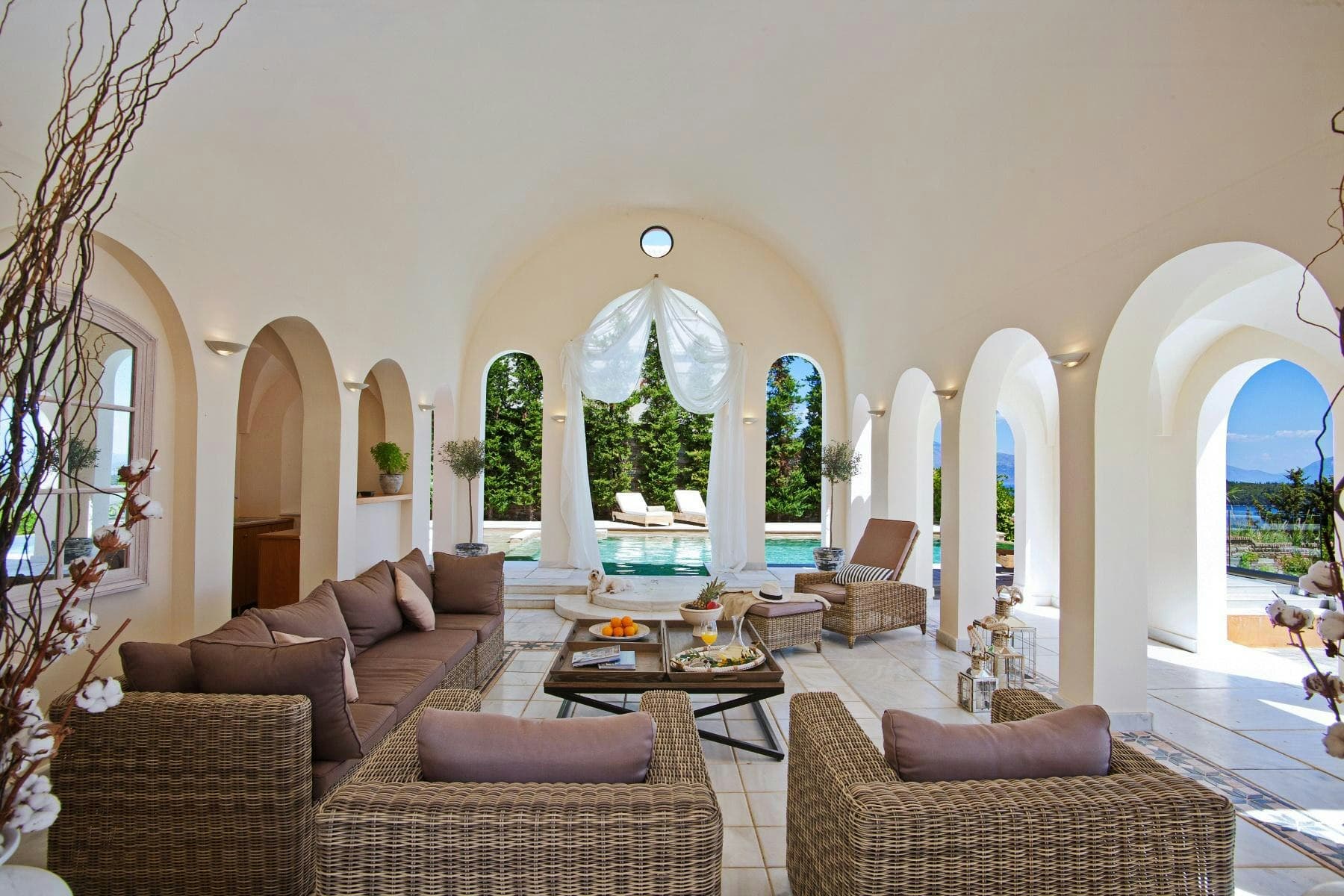 Heaven's Light open-air living room with arched colonnade and pool access, Lefkada, Greece
