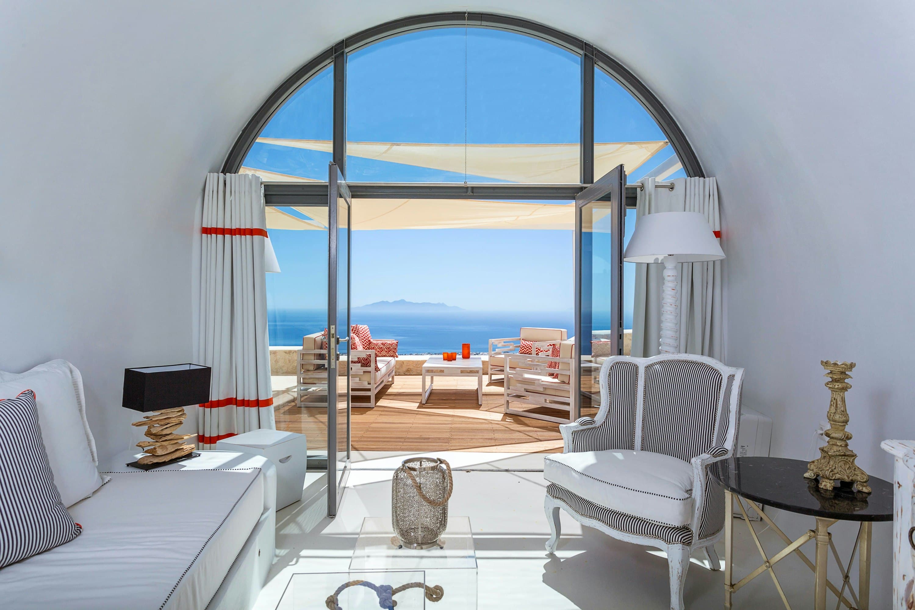 The Cycladic Rose white living room with arched terrace access, Pyrgos, Cyclades Islands, Greece