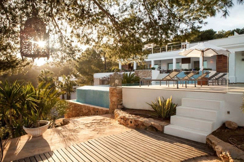 Moon Kite villa infinity pool and tiered stone terrace at golden hour, Sant Josep de sa Talaia, Ibiza