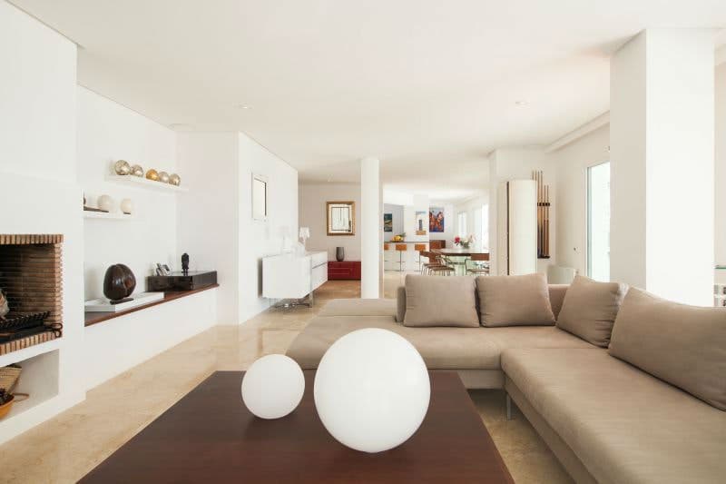 Moon Kite villa open-plan living room with sectional sofa and fireplace, Sant Josep de sa Talaia, Ibiza
