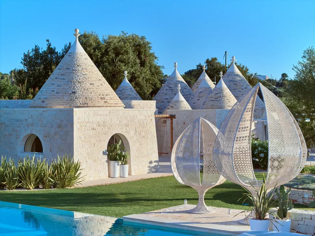Dimora Pomona poolside trulli architecture detail with filigree sculptures, Cisternino, Italy