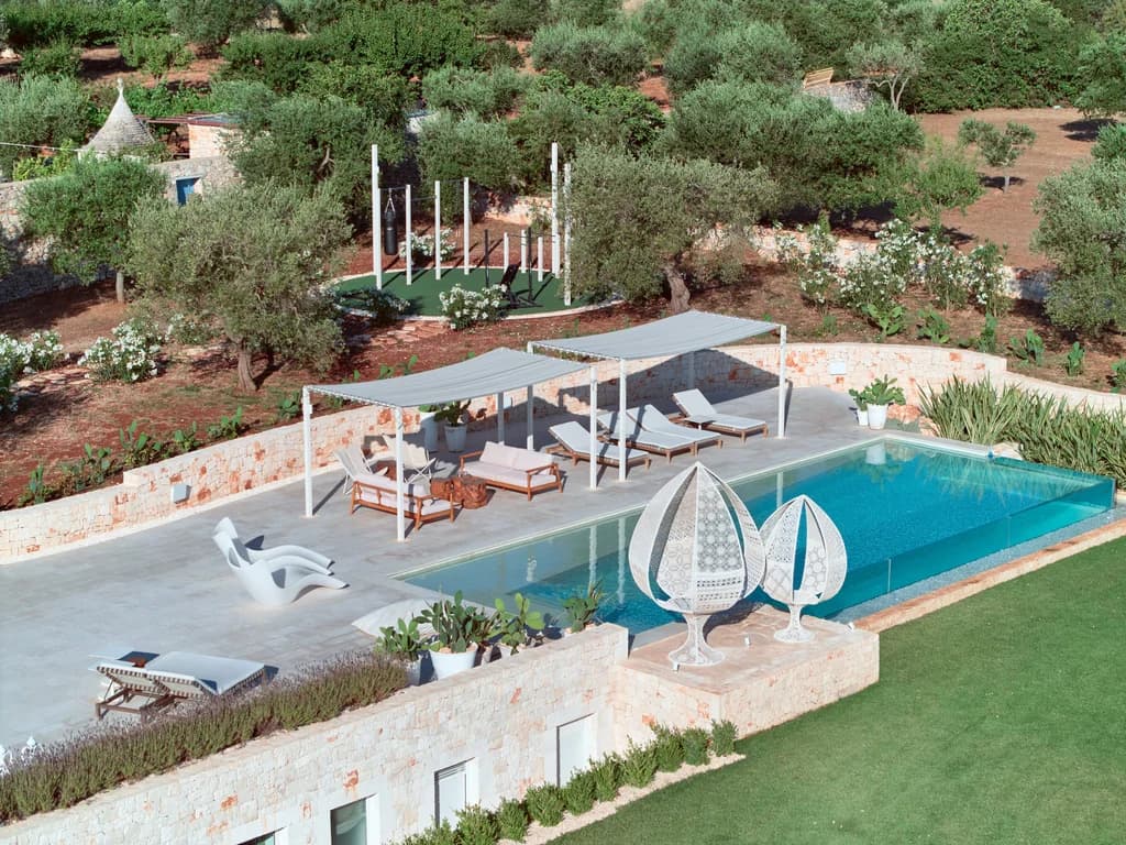 Dimora Pomona outdoor pool terrace with sun loungers and shade sails, Cisternino, Puglia, Italy