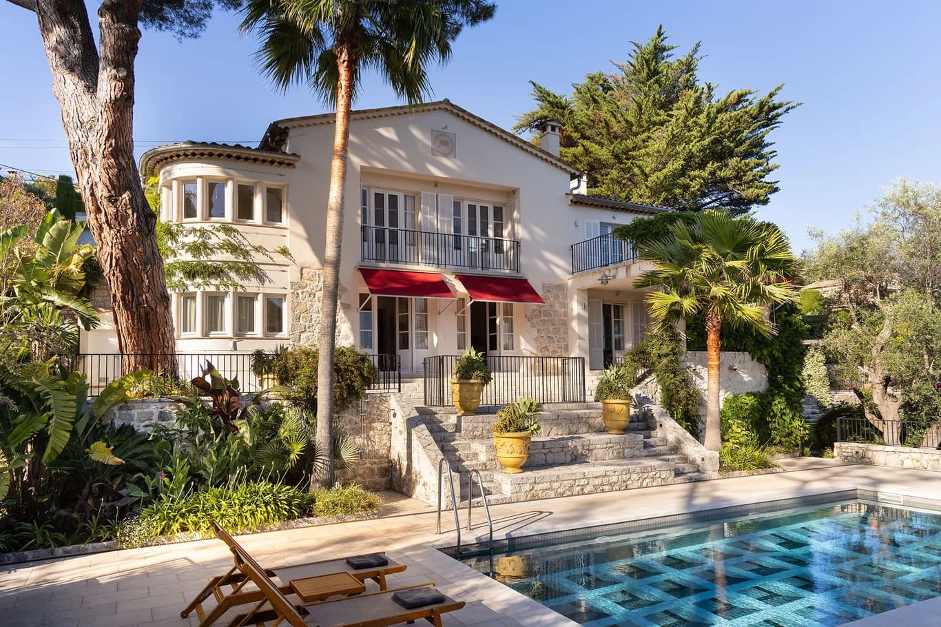 Villa Claudia grand stone façade with ornate balconies and pool, Vence, France
