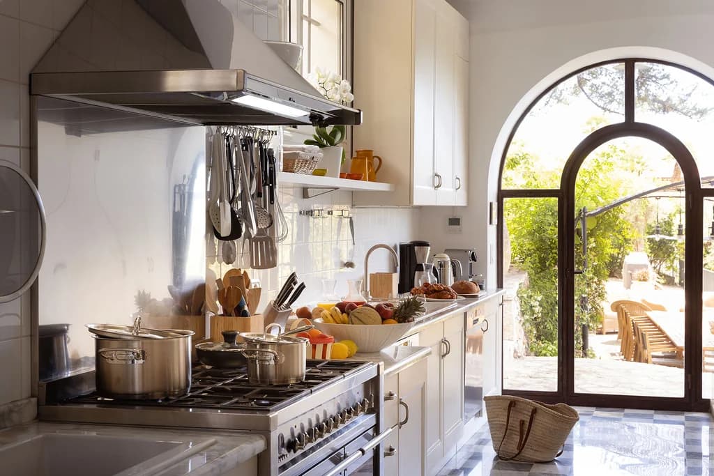 Villa Claudia gourmet kitchen with marble countertops and garden terrace door, Vence, France