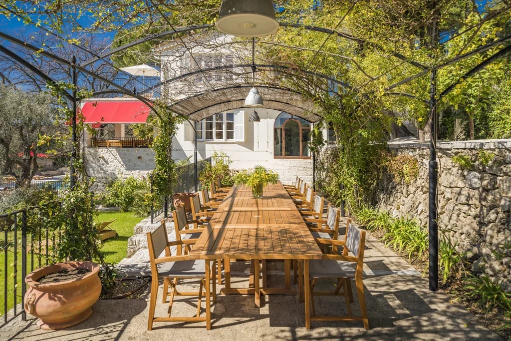 Villa Claudia outdoor pergola dining terrace with vine-covered ironwork, Vence, France