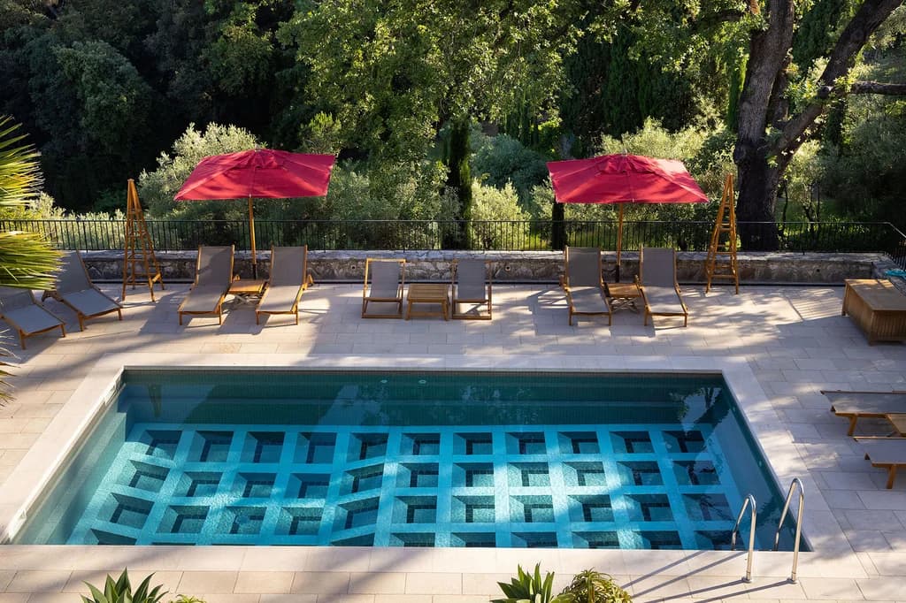 Villa Claudia mosaic pool with geometric tile design and travertine deck, Vence, France