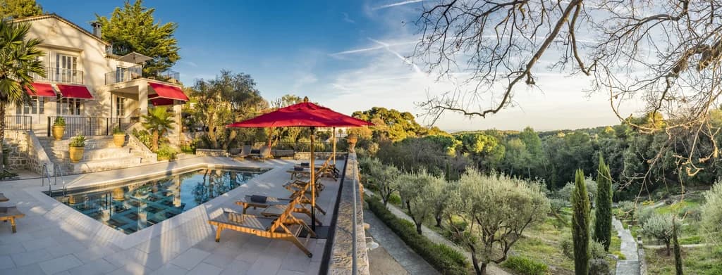 Villa Claudia outdoor pool terrace with olive grove views at golden hour, Vence, France