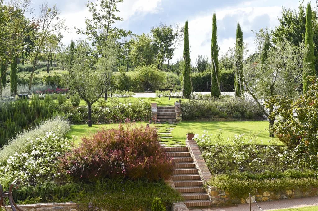 Il Pozzo landscaped terraced gardens with cypress trees and brick stairways, San Quirico d'Orcia, Italy