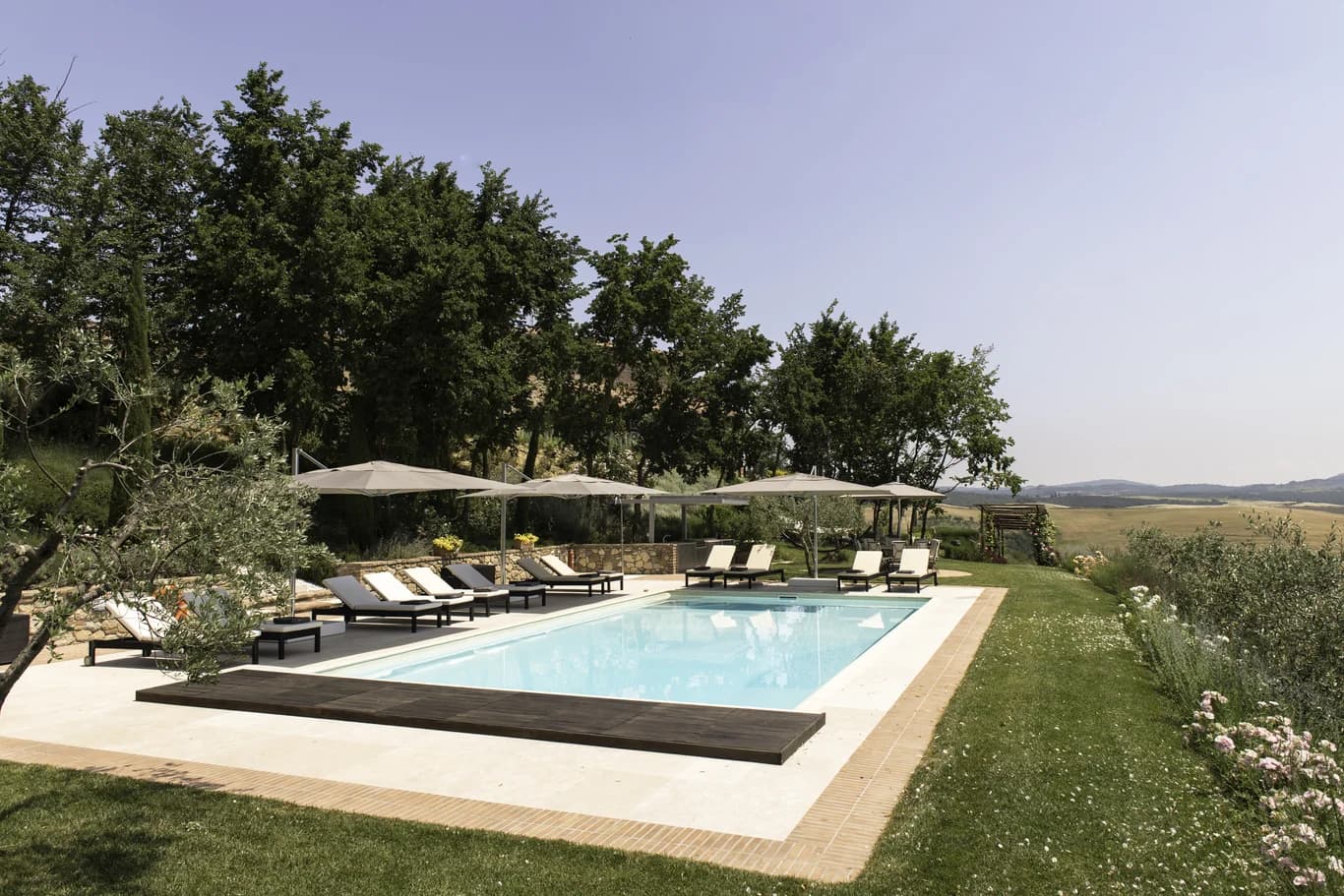 Il Pozzo outdoor pool with sun loungers and Tuscan valley views, San Quirico d'Orcia, Italy