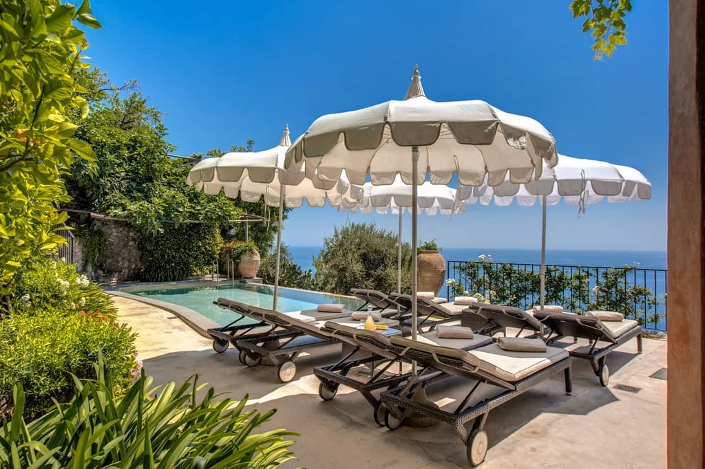 Villa San Giacomo outdoor pool terrace with sea views and sun loungers, Positano, Italy