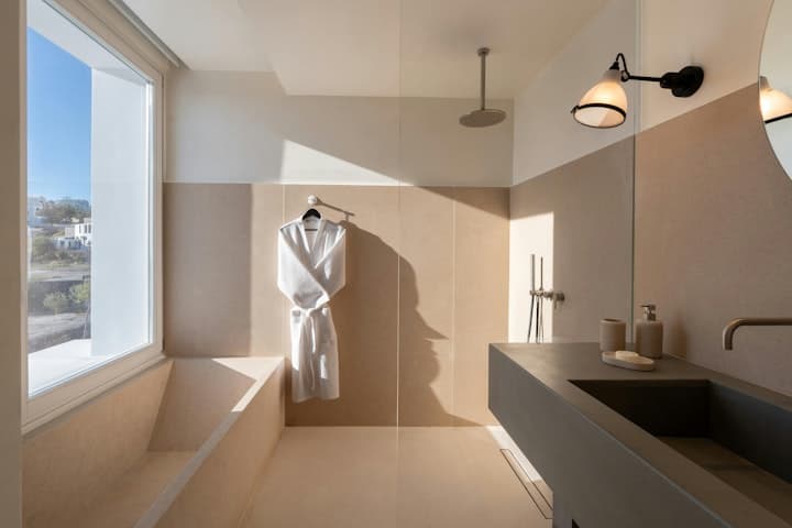 Earth Haven master bathroom with rainfall shower and natural light, Oia, Cyclades Islands, Greece