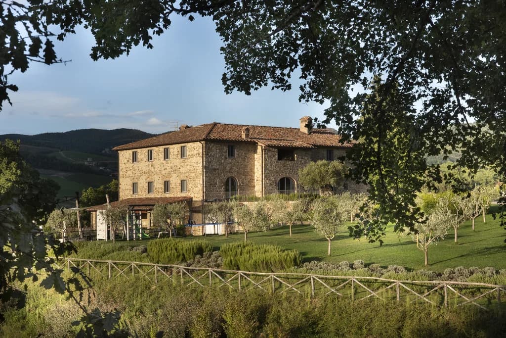 Villa Fieravista stone farmhouse exterior at golden hour, Radda in Chianti, Italy