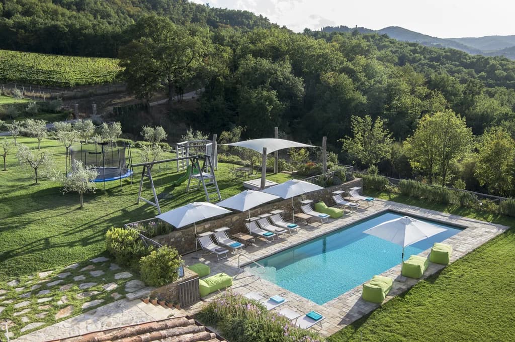 Villa Fieravista outdoor pool with stone terrace and Chianti hills, Radda in Chianti, Italy