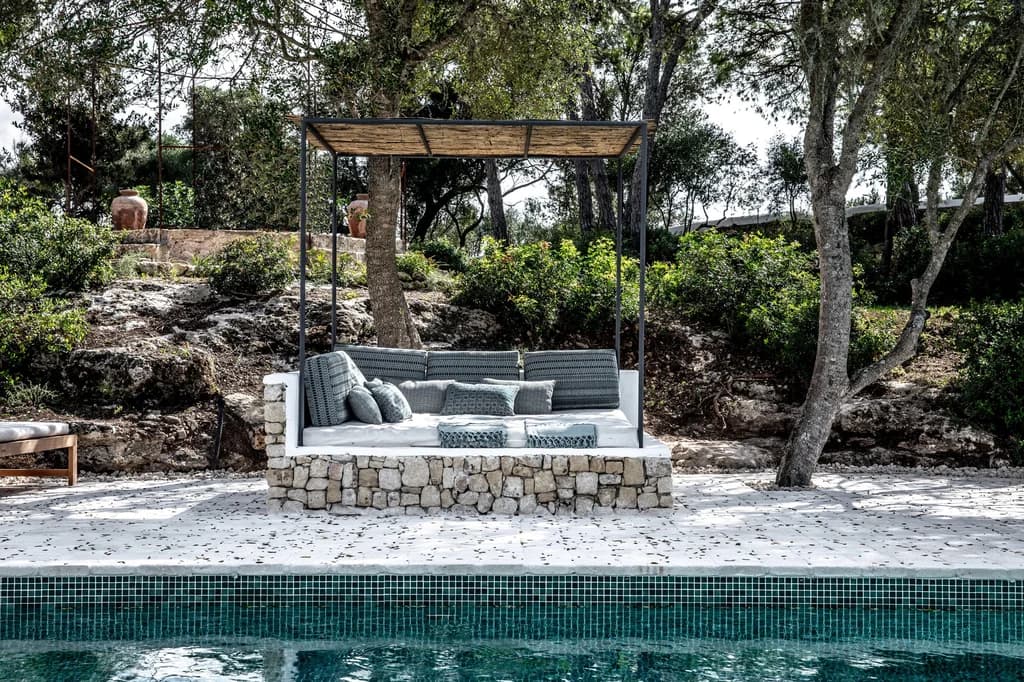 Montana del Aguila poolside cabana with dry-stone daybed and reed canopy, Menorca, Spain