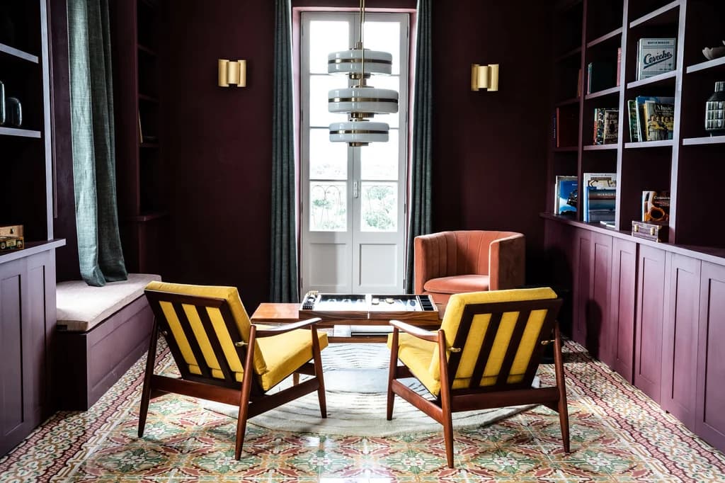 Montana del Aguila games and library room with encaustic tiles and armchairs, Menorca, Spain