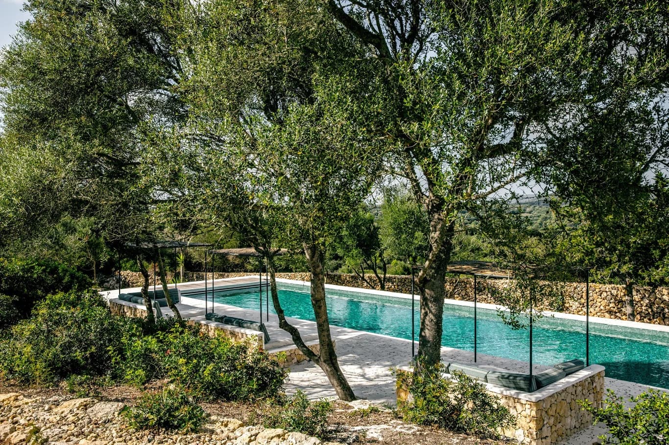 Montana del Aguila lap pool surrounded by olive trees and dry-stone walls, Menorca, Spain