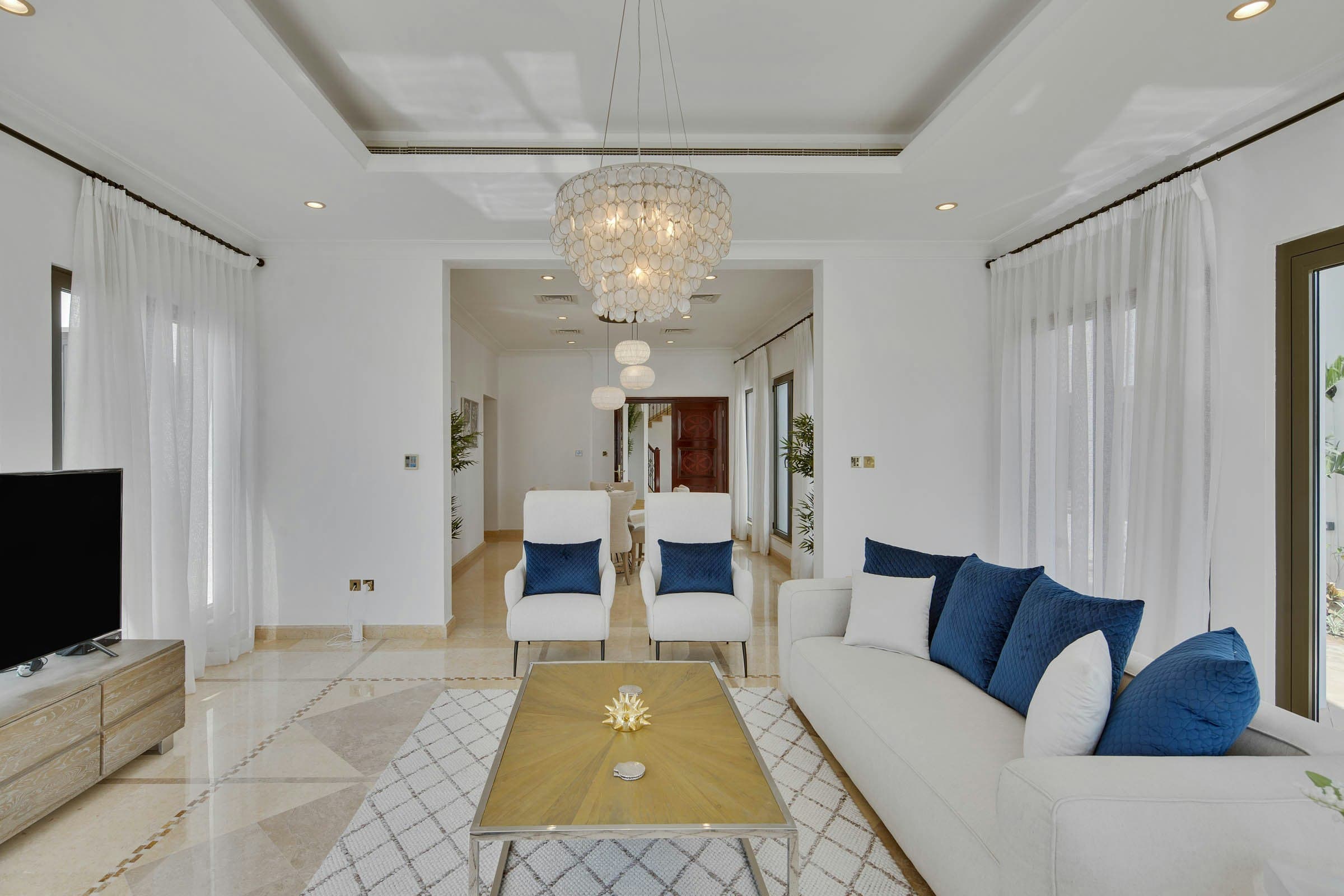 On the Palm formal living room with marble floors and chandelier, Dubai, United Arab Emirates
