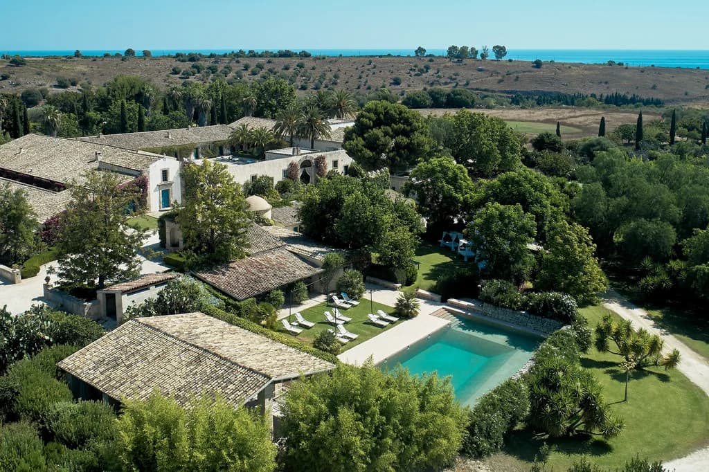 La Dimora del Santo aerial exterior view over estate, gardens and coastline, Brucoli, Sicily, Italy