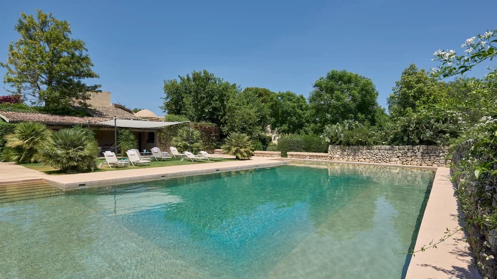 La Dimora del Santo private pool with sun loungers and stone walls, Brucoli, Sicily, Italy