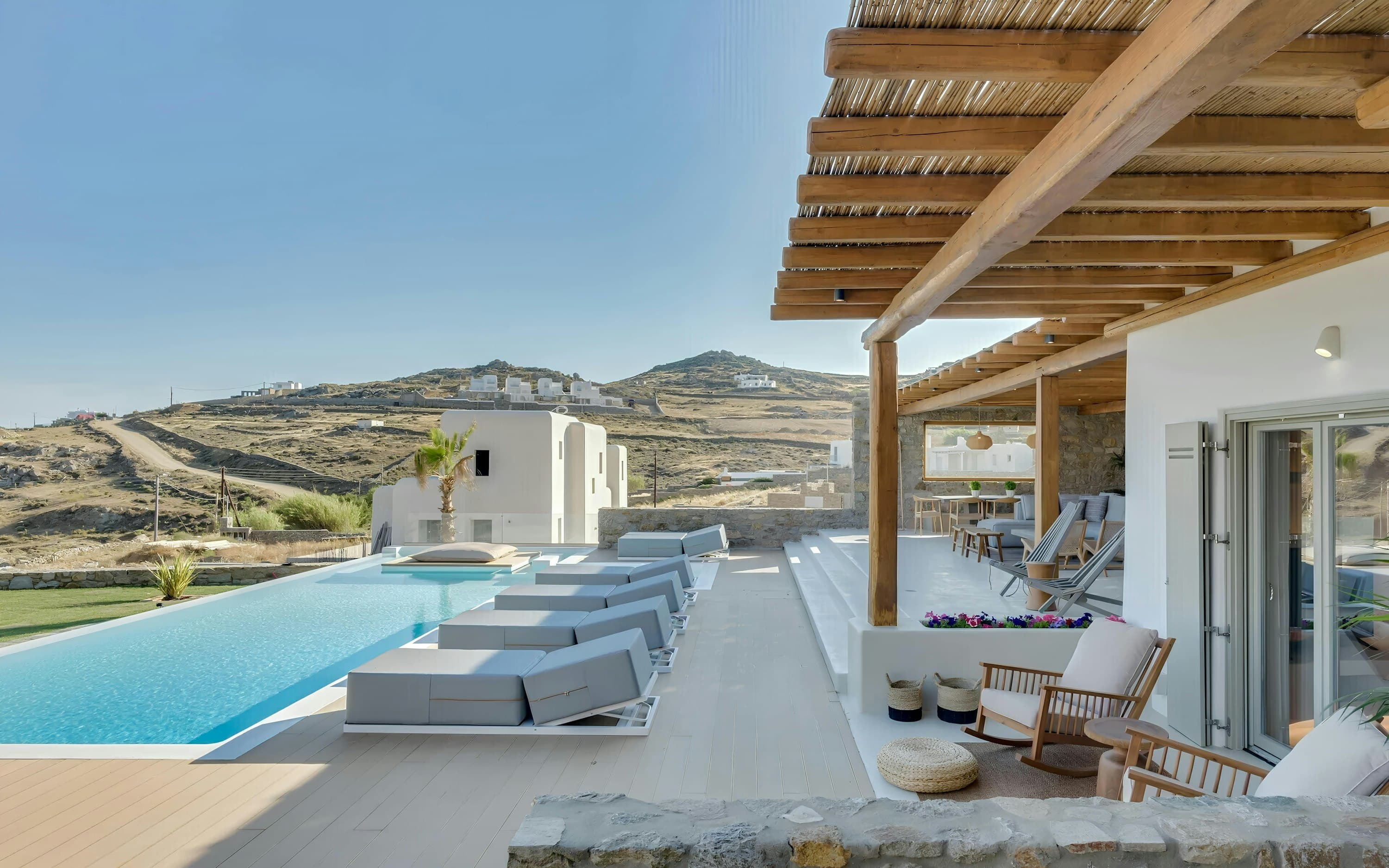 Seashore Silhouette pool deck terrace with designer loungers, Mykonos, Cyclades Islands, Greece