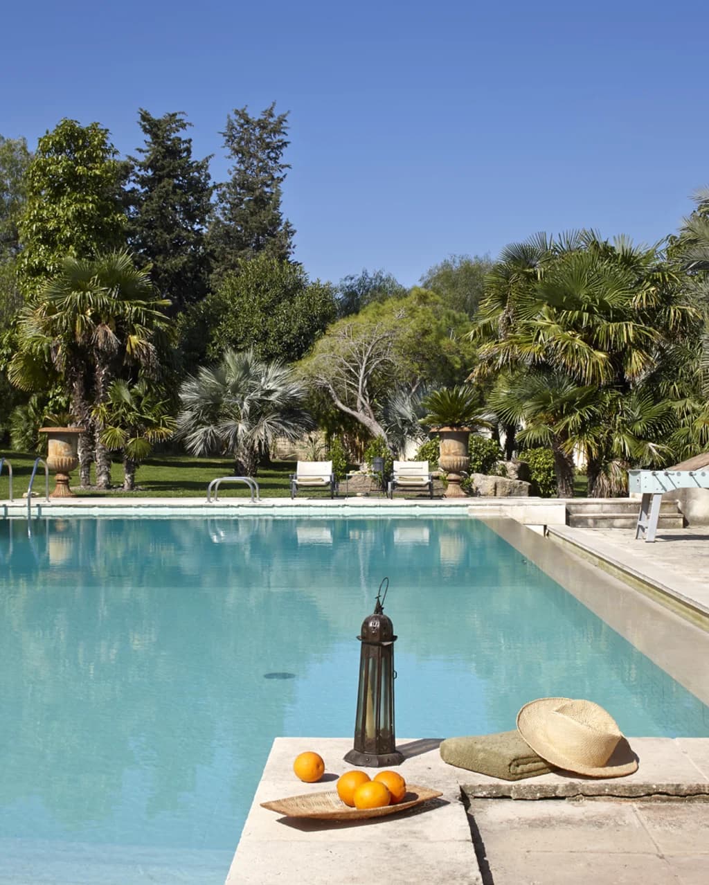 Tenuta di San Giorgio outdoor pool terrace with palms and Sicilian details, Scordia, Sicily, Italy