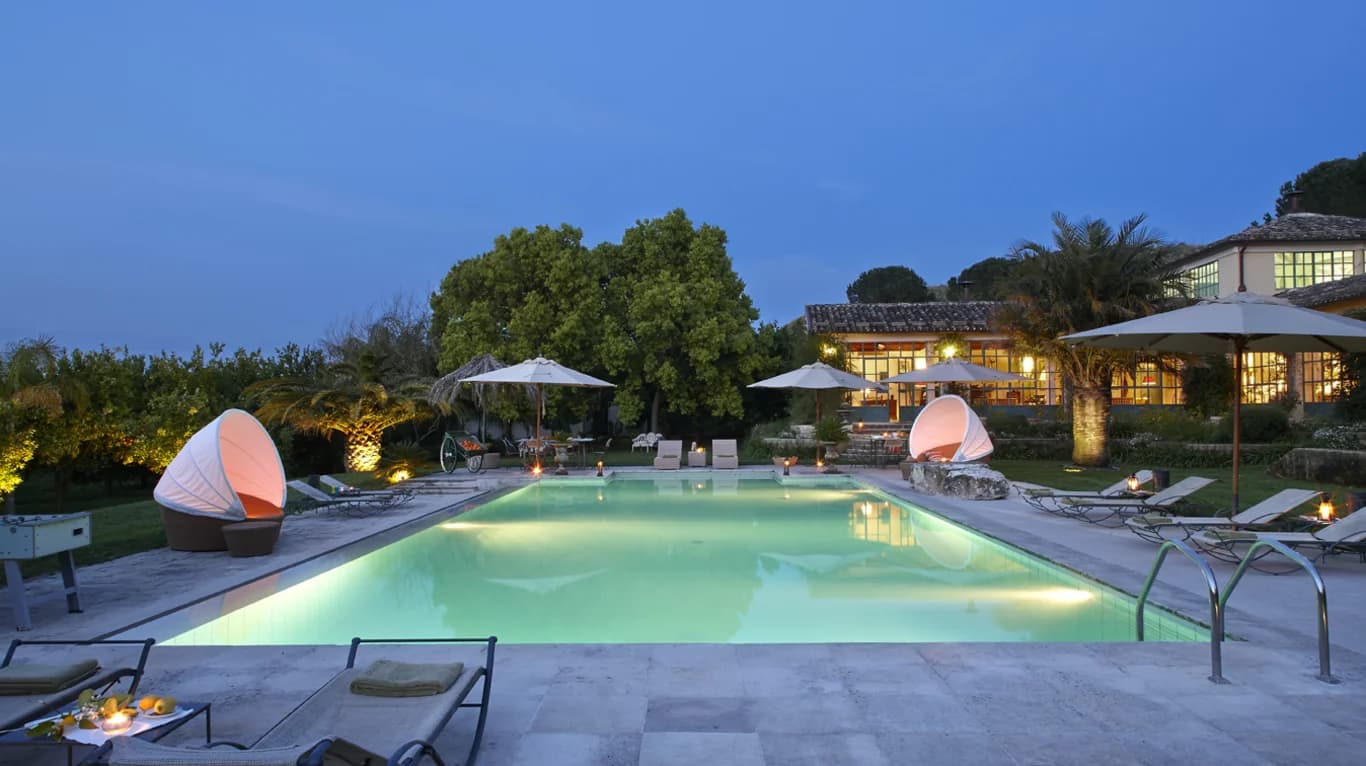 Tenuta di San Giorgio outdoor pool at evening with underwater lighting, Scordia, Sicily, Italy