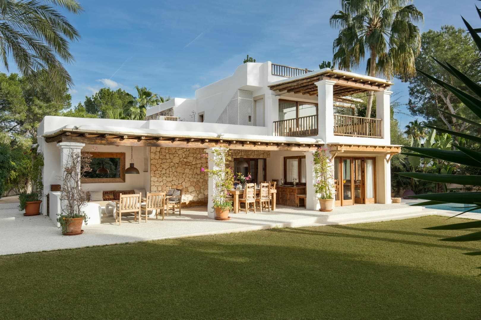 Stone Sanctuary villa exterior with white stucco and natural stone, Sant Josep de sa Talaia, Spain