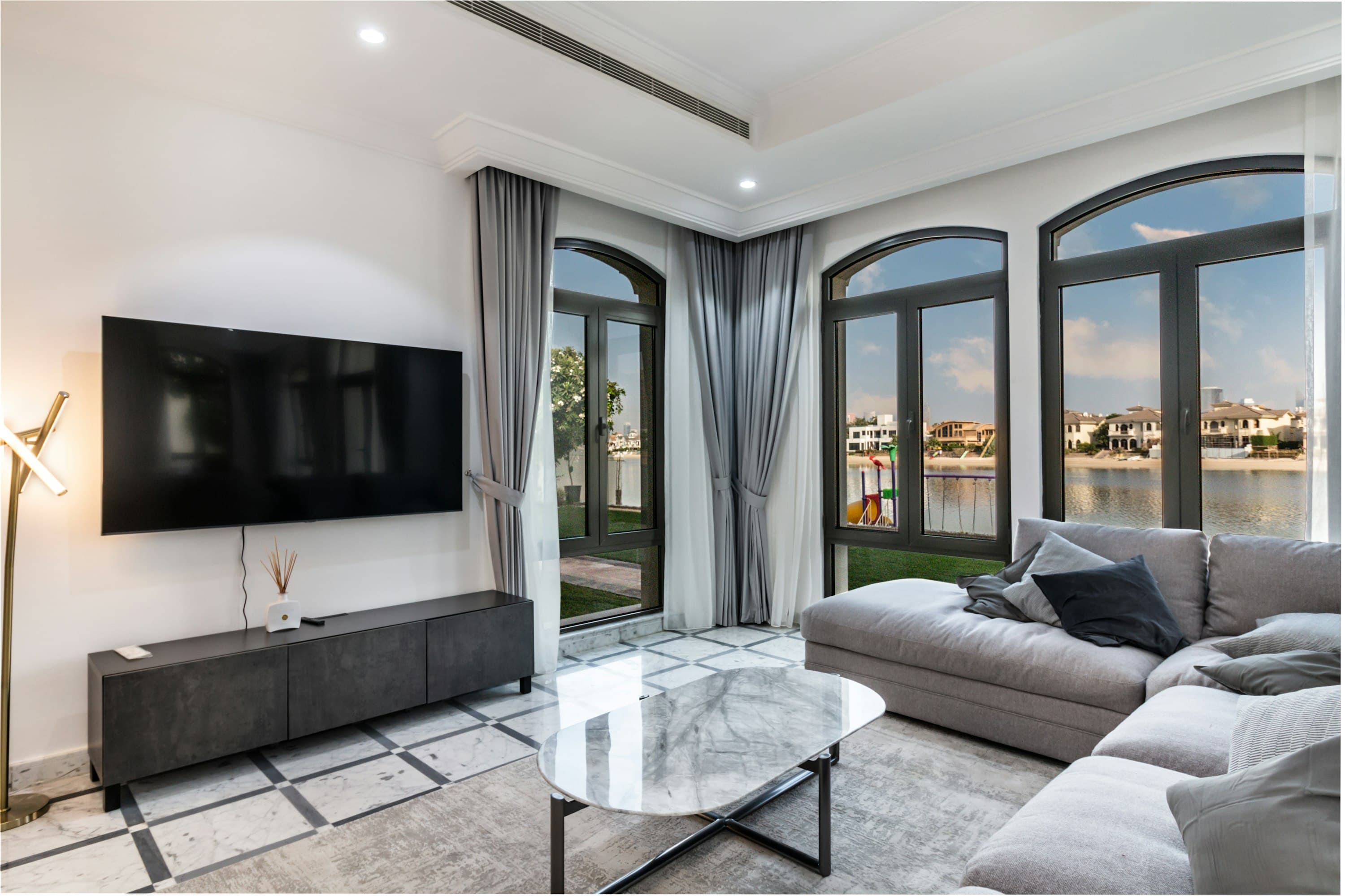 Summer on the Water waterfront living room with arched French doors, Dubai, UAE