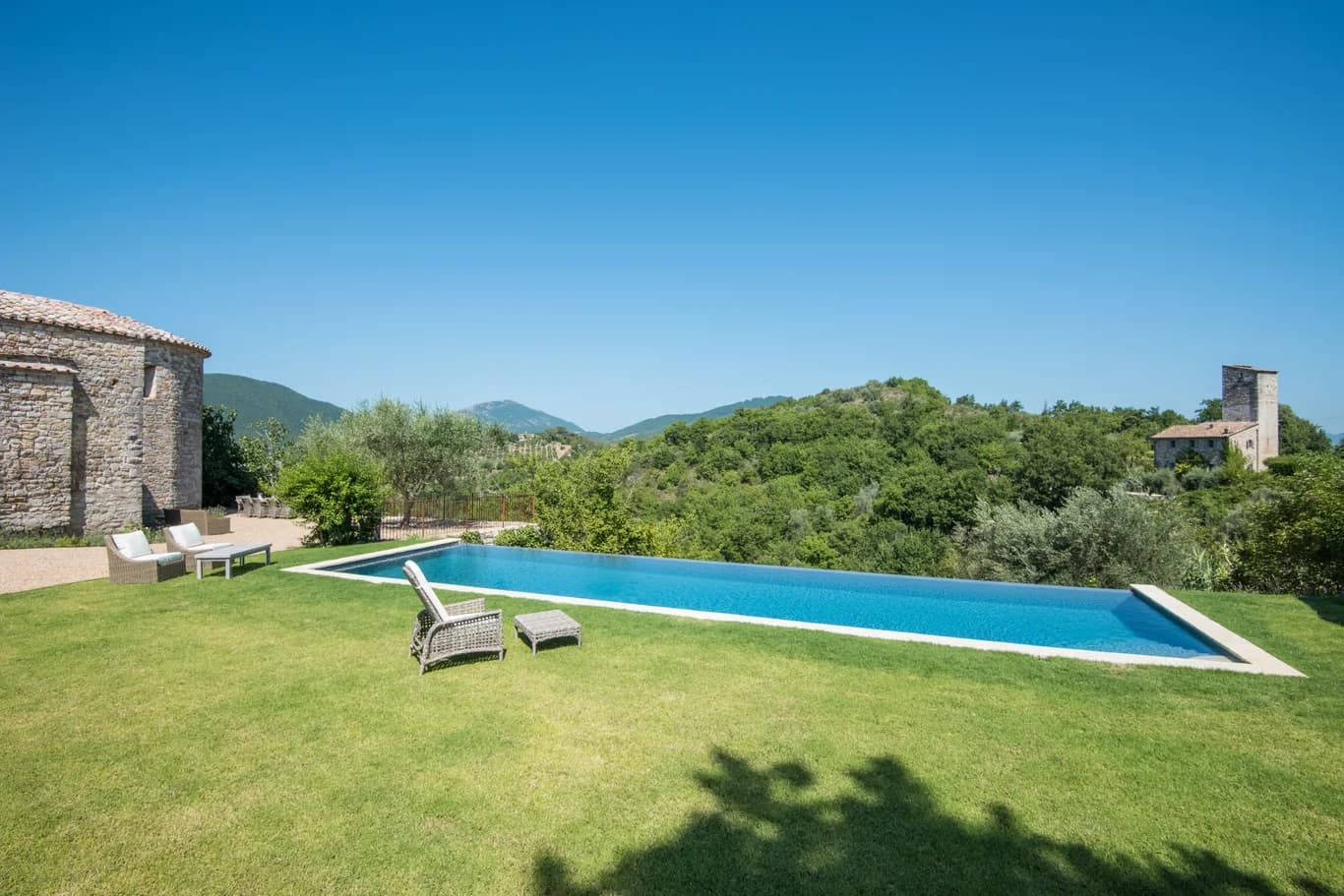 Colle Alto villa infinity pool overlooking forested Umbrian hills, Umbertide, Italy