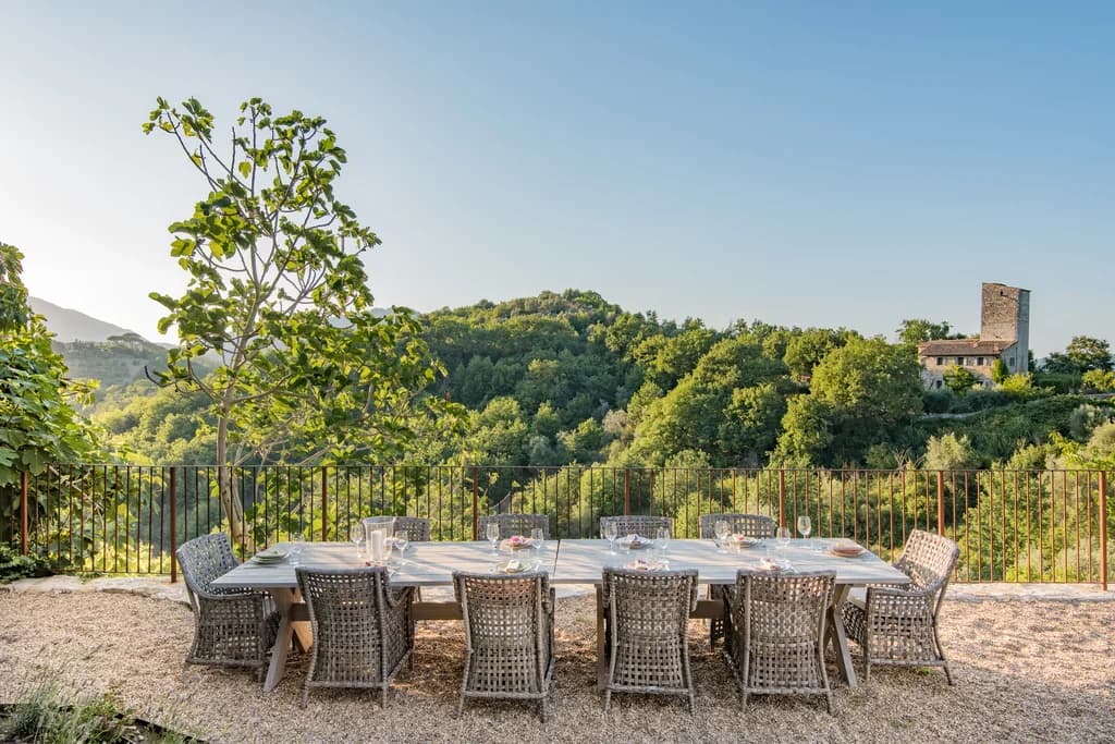 Colle Alto villa outdoor dining terrace for ten with valley views at golden hour, Umbertide, Italy
