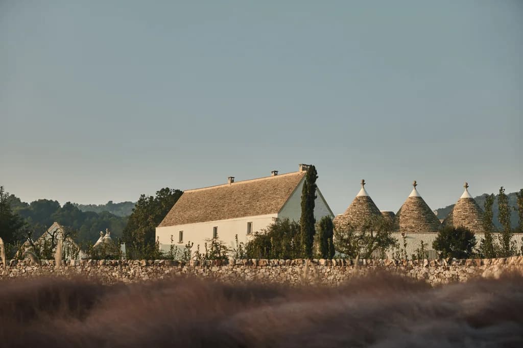 Masseria Giardini estate silhouette with trulli cones at dawn, Alberobello, Italy