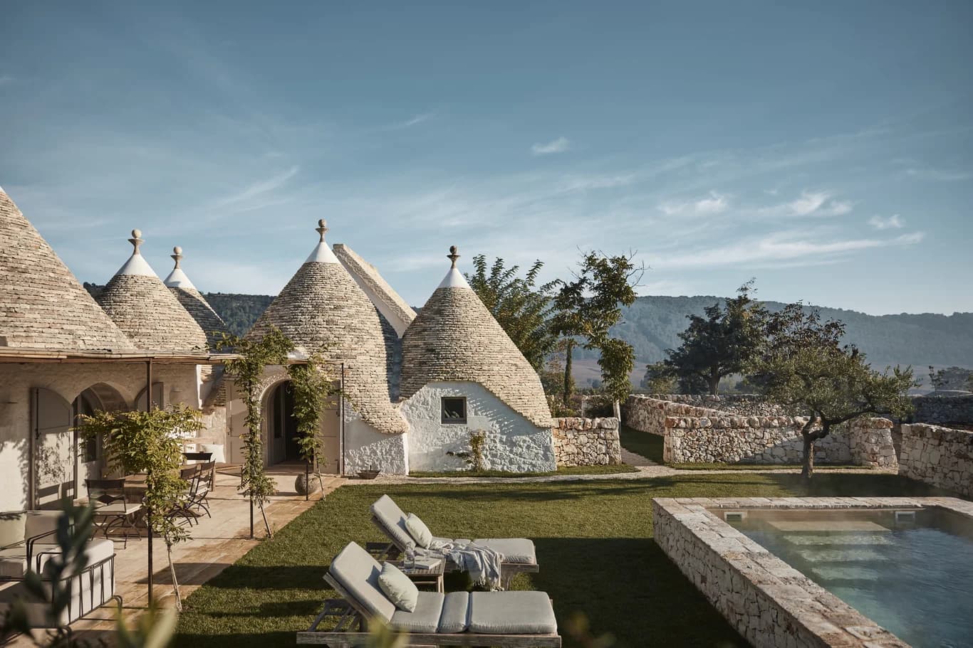 Masseria Giardini private pool terrace with trulli roofs and Puglian hills, Alberobello, Italy