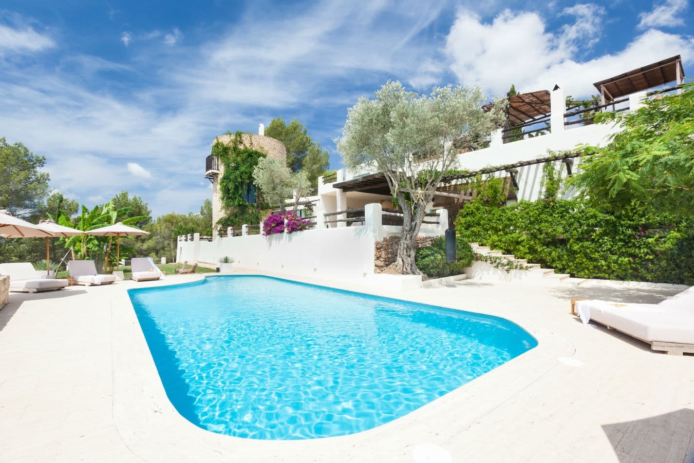 St Vetiver curved infinity pool with sun loungers and terraces, Santa Eulària des Riu, Spain