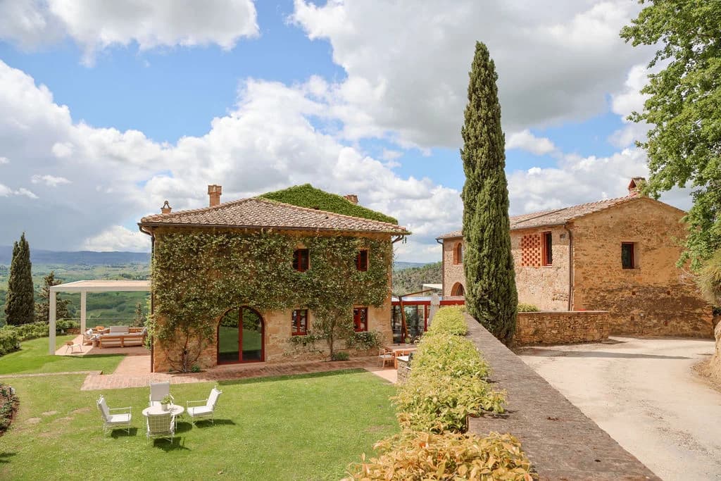 Il Santuario ivy-clad stone farmhouse exterior with cypress trees, Barberino Tavarnelle, Italy