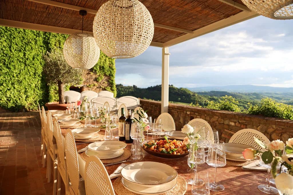Il Santuario alfresco dining pergola with globe lights and countryside views, Barberino Tavarnelle, Italy