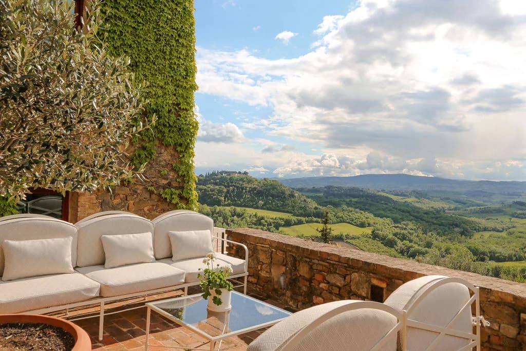 Il Santuario outdoor lounge terrace with olive tree and valley views, Barberino Tavarnelle, Italy