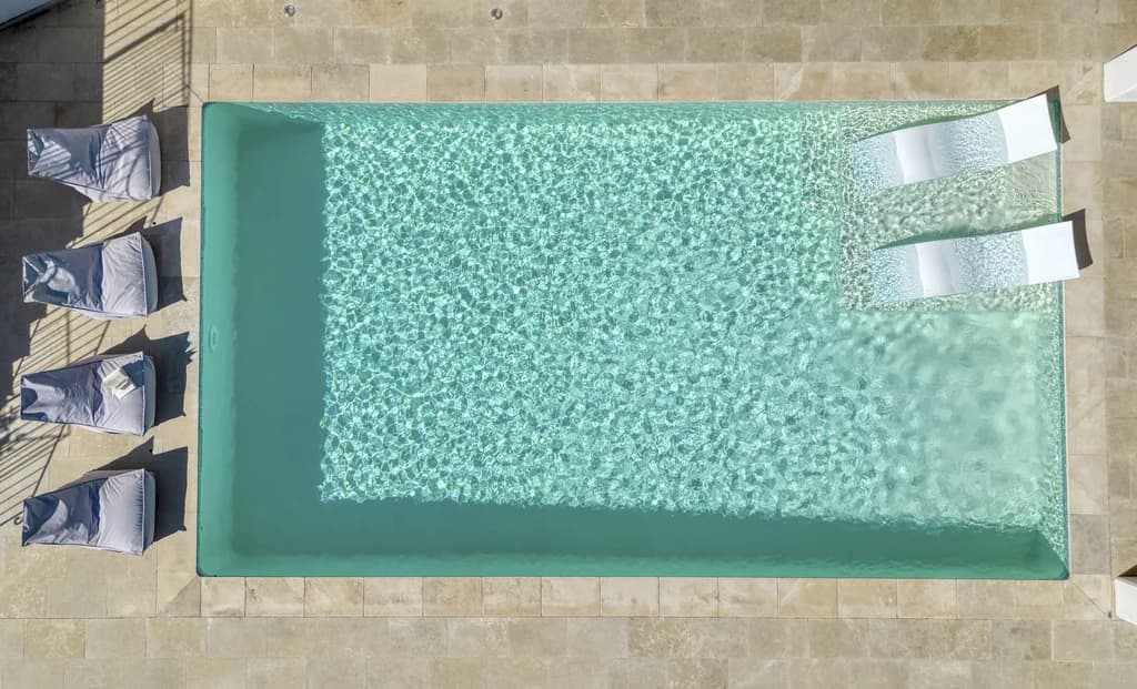 Villa Enchantée outdoor pool with sunbathing steps and stone deck, Le Rouret, France