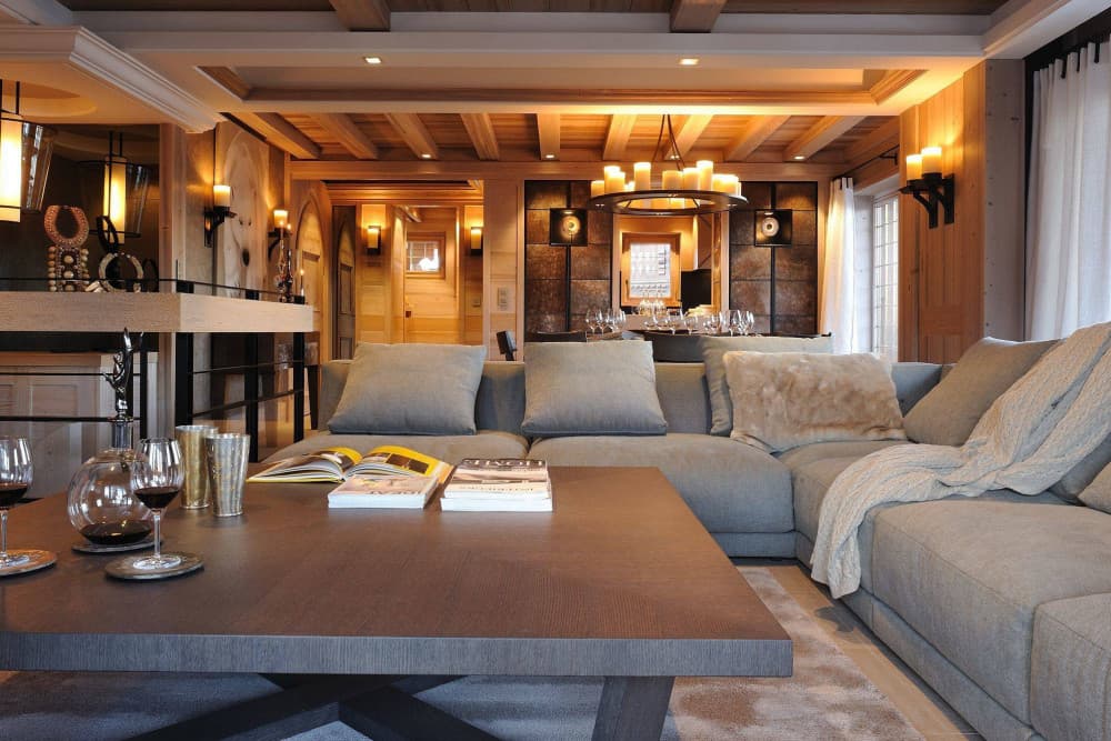 Courchevel 37 open-plan living room with timber ceiling and chandelier, Courchevel 1850, France