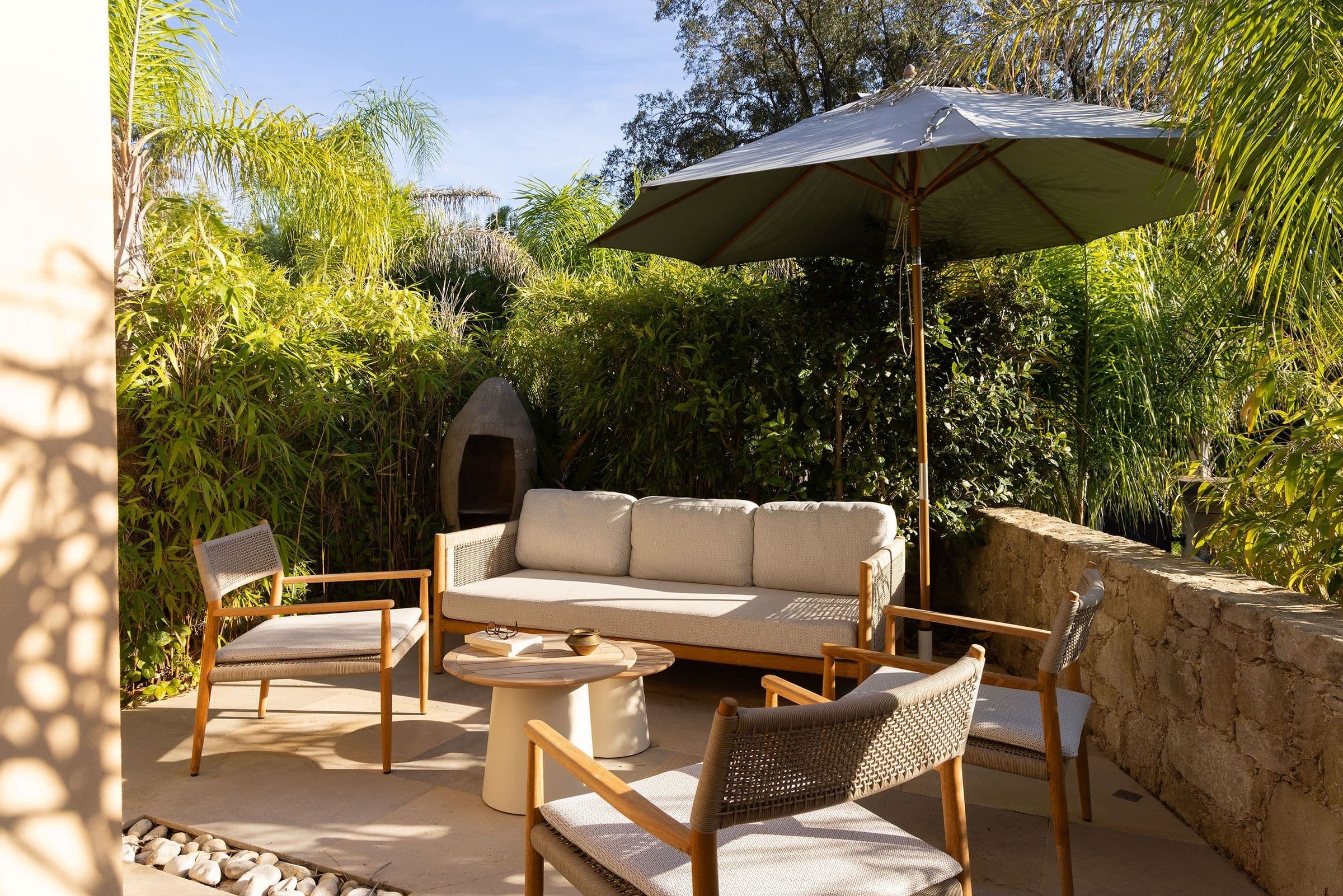 Villa Maï Taï outdoor dining terrace with reclaimed wood table, Saint-Tropez Peninsula, France