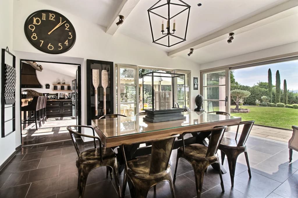 Villa Paradis elegant indoor dining room with glass table and garden doors, Sainte-Maxime, France