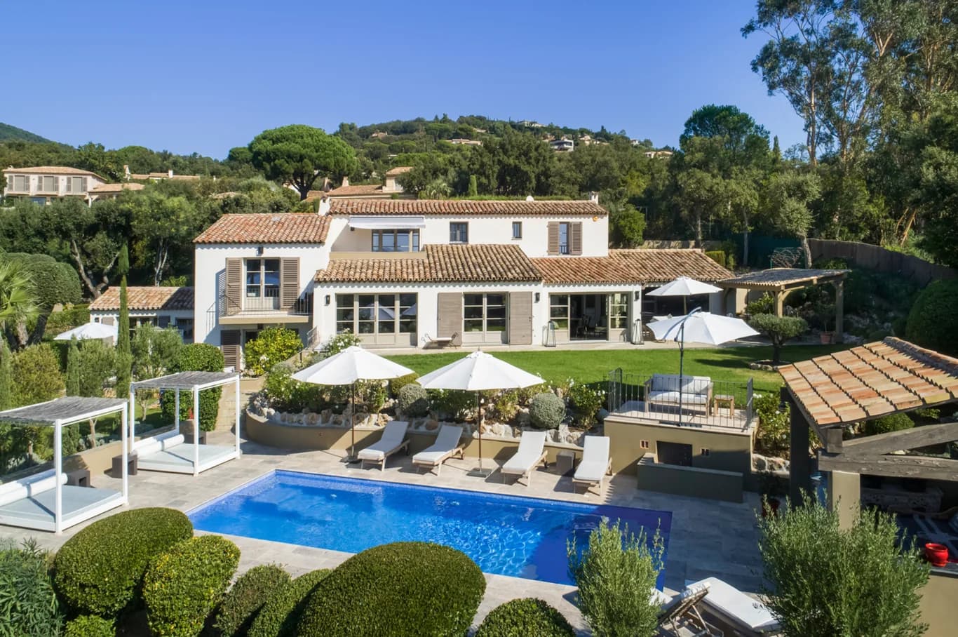 Villa Paradis aerial exterior with terracotta roof, azure pool and topiary gardens, Sainte-Maxime, France
