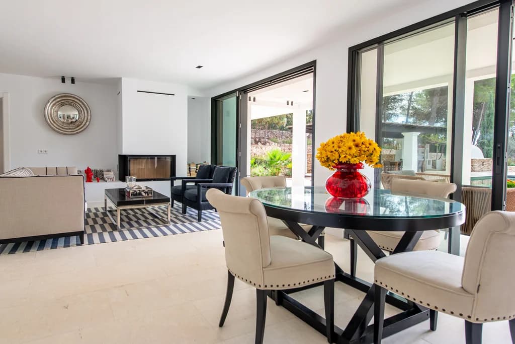Villa Gertrudis indoor dining area with glass table and terrace access, Ibiza, Spain