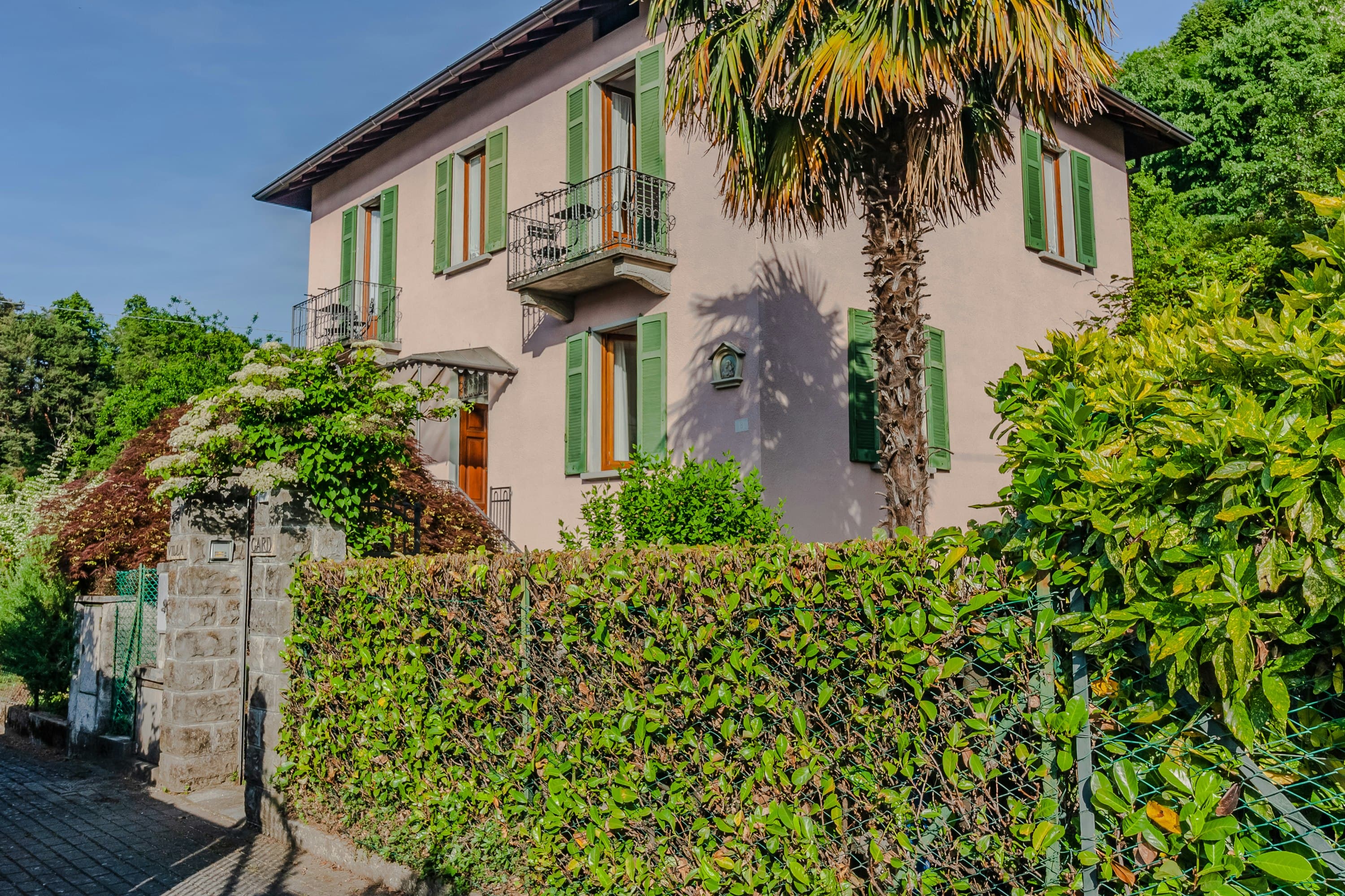 So Bellagio villa exterior with green shutters and ornate balconies, Bellagio, Italian Lakes, Italy