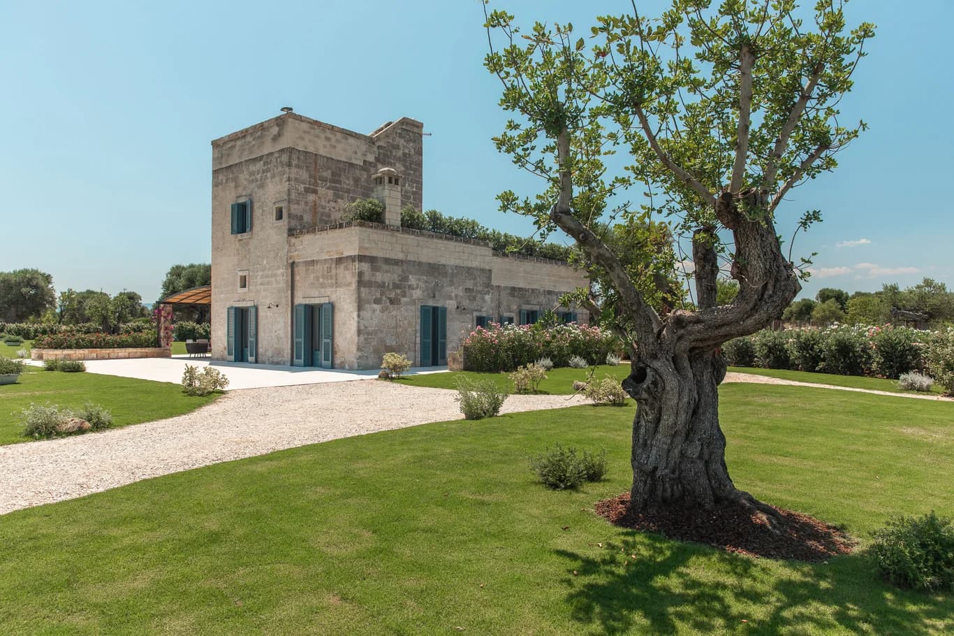 La Piccola Torre garden exterior with ancient olive tree and limestone tower, Savelletri, Puglia, Italy