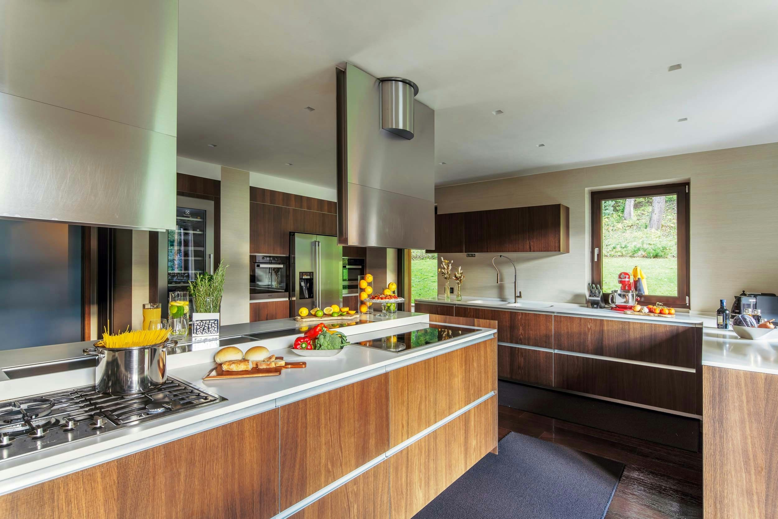 Dolomite Prestige chef kitchen with dual islands and walnut cabinetry, Cortina d'Ampezzo, Italy