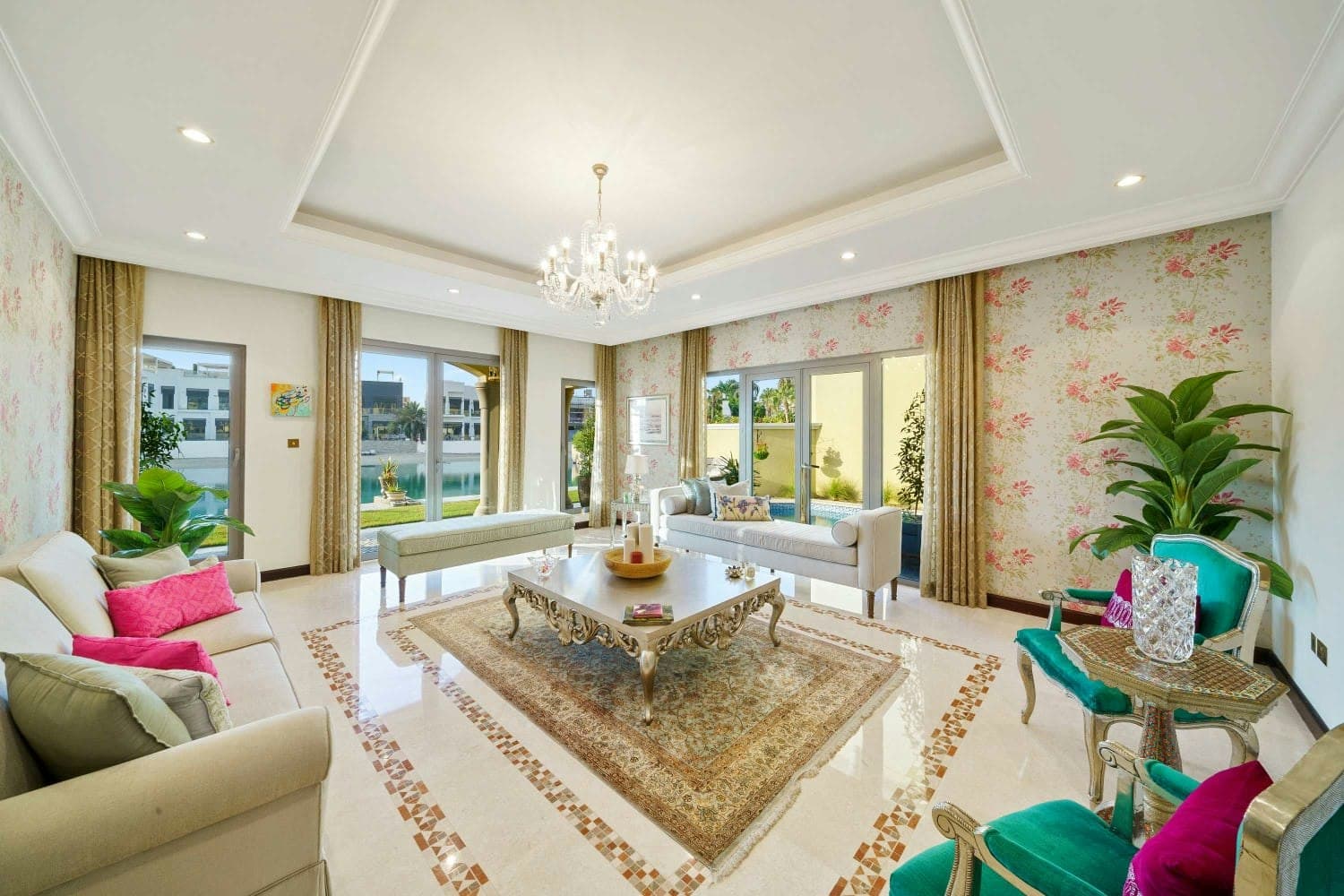 A Place in the Palms formal living room with chandelier and pool views, Dubai, United Arab Emirates