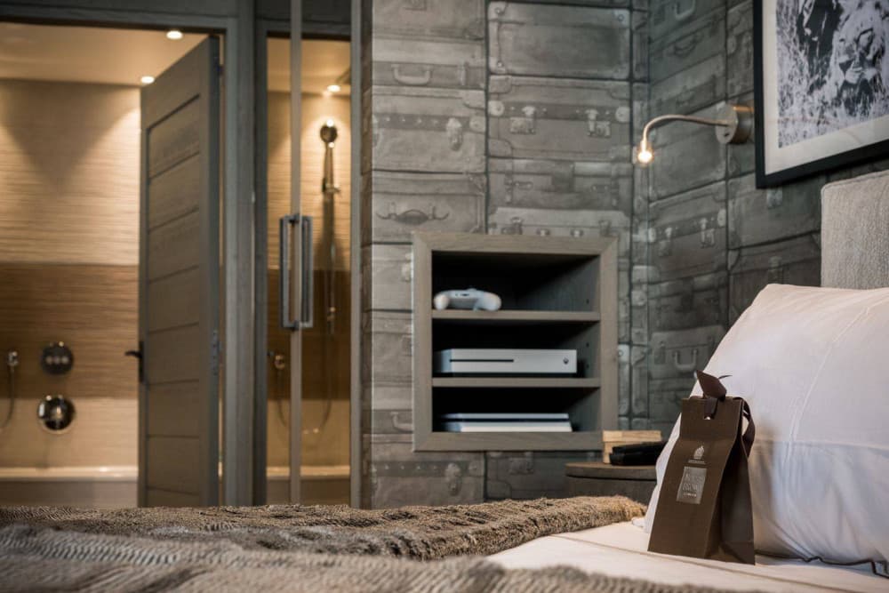 Courchevel 38 junior master bedroom with antler chandelier and star wallpaper, Courchevel 1850, France